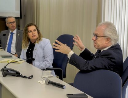 Imagem mostra, da esquerda para a direita, Manuel Palácios, Sandra Goulart e Alessandro Moreira, sentados em mesa durante reunião na Reitoria