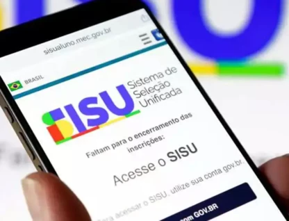 Imagem de uma mão com um celular no qual está aberto o site do Sisu